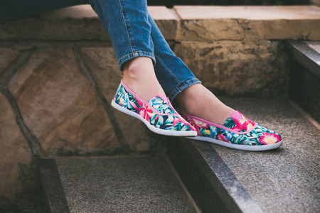 woman feet in colorful summer espadrilles on stairs outdoor shotの写真素材