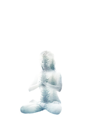 young woman in lotus position double exposure with nature backgroundの写真素材