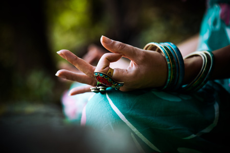 closeup of woman hand with rings and bracelets practice yoga outdoor shotの写真素材