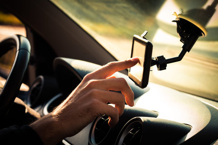 man  adjusting  gps in car closeup