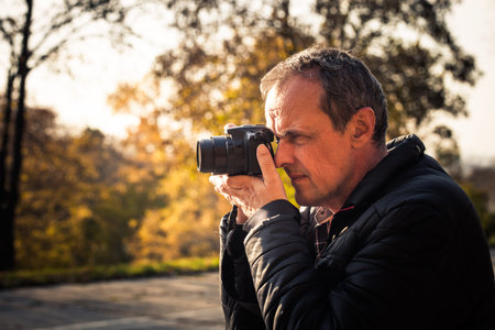 photographer take photo with digital camera outdoor shot autumn day