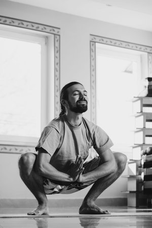 young man doing yoga  indoor healthy lifestyle concept