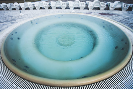 hot thermal spa bathtub round pool cold winter dayの写真素材