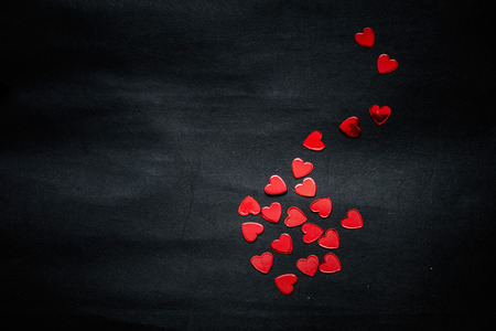 red hearts on black paper background Valentines day symbolの写真素材