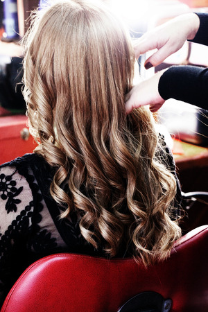 blond woman with long hair in hair studio back viewの写真素材