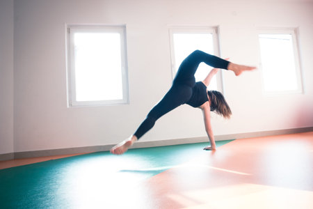 young dancer woman practice floor jump on modern ballet class indoor shot
