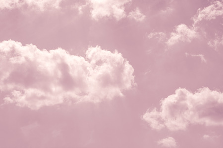 fantasy pastel pink sky with white fluffy  cloudsの写真素材