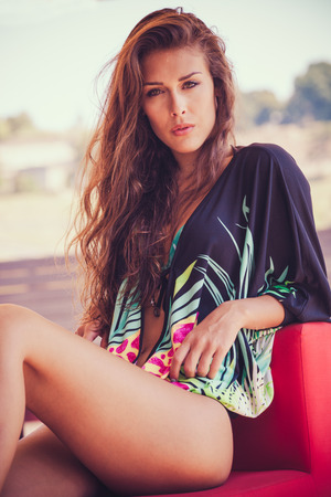 summer fashion girl in tunic  and bikini sit in cafe by the pool hot summer dayの写真素材