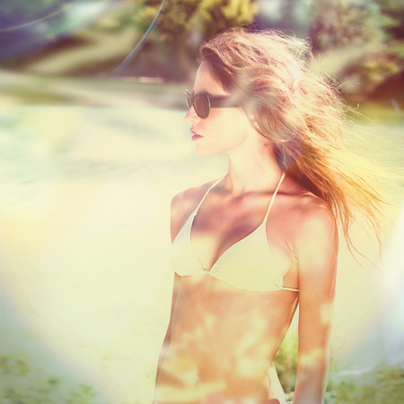 girl in bikini and sunglasses portrait outdoor by the river summer timeの写真素材