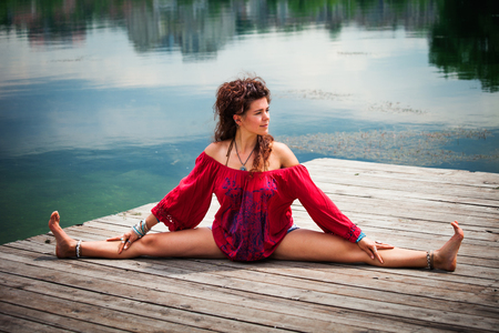 young woman practice yoga outdoor by the lake healthy lifestyle conceptの写真素材