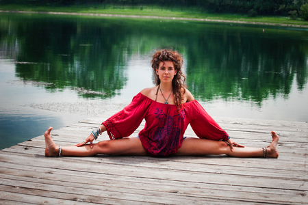 young woman practice yoga outdoor by the lake healthy lifestyle conceptの写真素材