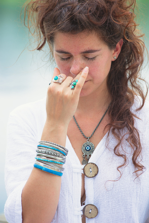 young woman practice yoga breathing techniques  outdoor by the lake healthy lifestyle concept medical alternativeの写真素材