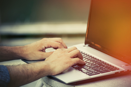young man hands closeup using laptop outdoor day shot start up conceptの写真素材