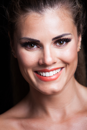 smiling blonde young woman beauty  portrait with perfect white teeth studio shotの写真素材