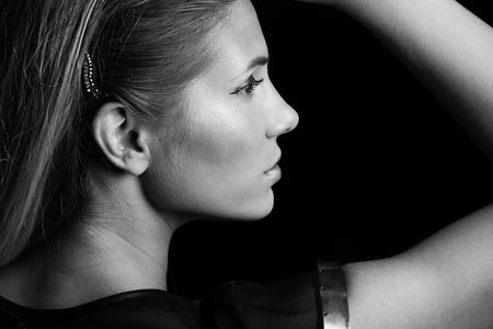 young beautful blonde girl portrait profile in black and white studio shotの写真素材