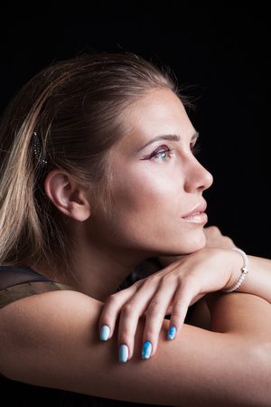 beauty portrait of blonde girl with wet eye shadow profile long hair studio shotの写真素材