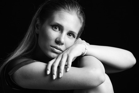 young beautful blonde girl portrait in black and white studio shotの写真素材