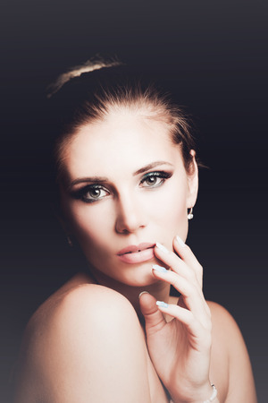 young blonde woman beauty portrait front view studio shotの写真素材