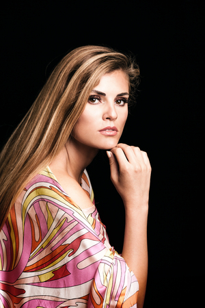 beauty young blonde woman portrait in colorful silky dress studio shotの写真素材