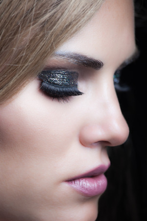 beauty young woman portrait with glittering evening makeup closeup studio shotの写真素材