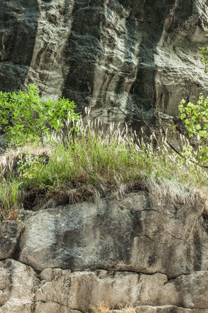 closeup of layers of rocks in a small mountain canyon backgroundの写真素材