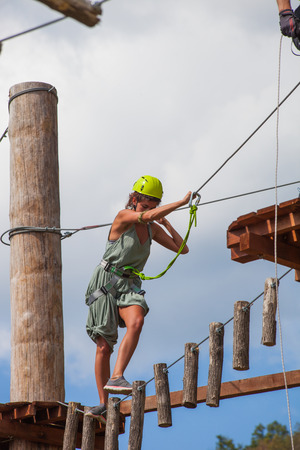 young woman in adventure park challenge conceptの写真素材