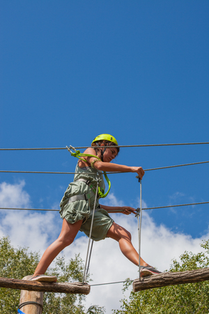young woman in adventure park challenge conceptの写真素材