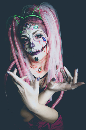 scary halloween woman with sugar skull makeup studio shotの写真素材