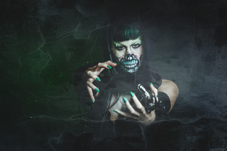 scary assasin undead woman with finger claw studio shotの写真素材