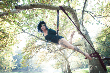 young woman aerial hoop  dance in forestの写真素材