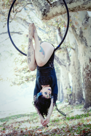young woman aerial hoop  dance in forestの写真素材