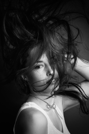 young woman  portrait with hair in motion  in black and whiteの写真素材