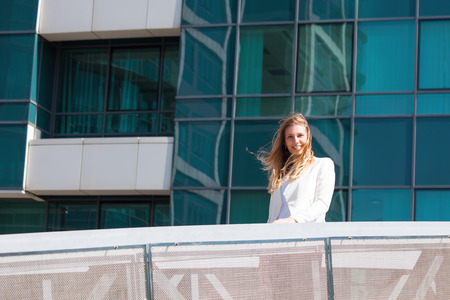 portrait of young smiling blonde business woman outdoor in the city の写真素材