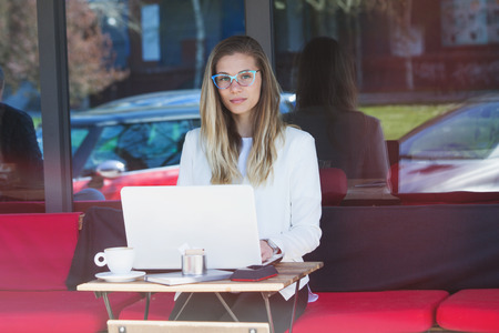 student woman sit in cafe with laptop, outdoor shot の写真素材