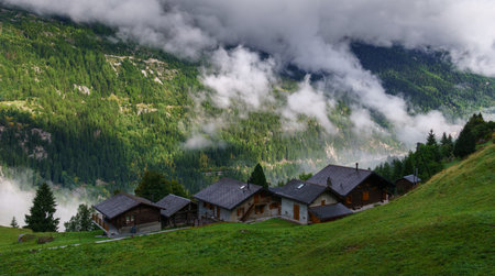 Panorama of beautiful alpine village high in clouds