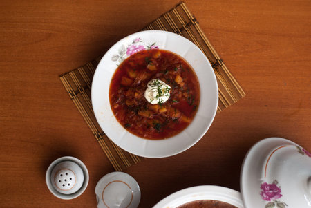 Borsch -traditional russian soup with red beets on the wooden background