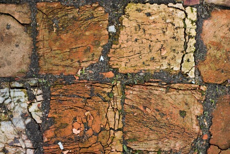 the texture of the old bricks made of clay, with cracks and splitsの写真素材