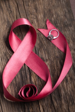 pink ribbon with ring, gifts for women's dayの写真素材