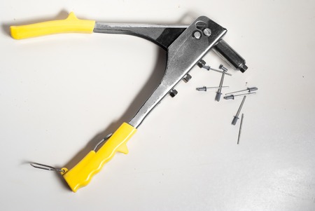 rivets and rivet pliers isolated on white backgroundの写真素材