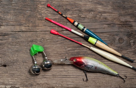 Fishing tackle and bait, on wooden backgroundの写真素材