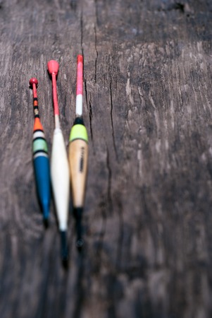 Fishing floats assorted colors. On wooden backgroundの写真素材