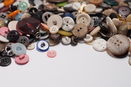 set of different buttons. tablewith copy space. close up. white backgroundの写真素材