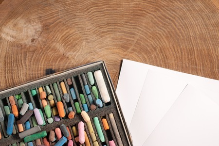 Soft pastels for artists and drawing paper on the wooden tableの写真素材