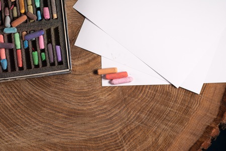 Soft pastels for artists and drawing paper on the wooden tableの写真素材