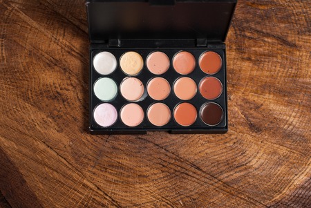 Cosmetic palette Foundation powder on wooden tableの写真素材