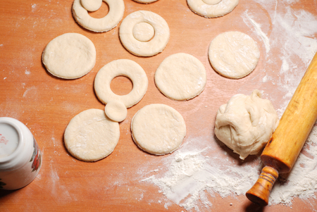 The pastry chef prepares the donuts from dough, top viewの写真素材