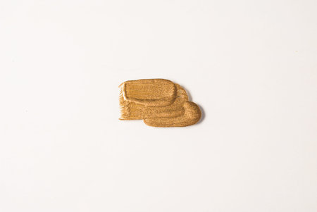 DAB of Golden yellow paint on a white background
