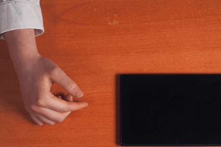 The girl working with digital tablet on wooden tableの写真素材