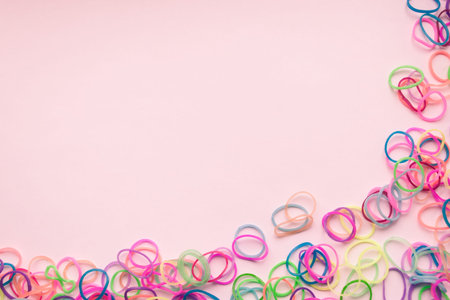 colorful set of rubber bands for hair on light background, copy space