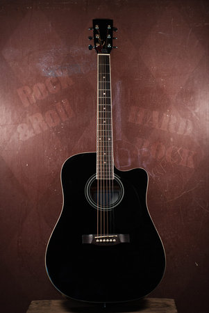 Acoustic black guitar on a background in style of grunge
